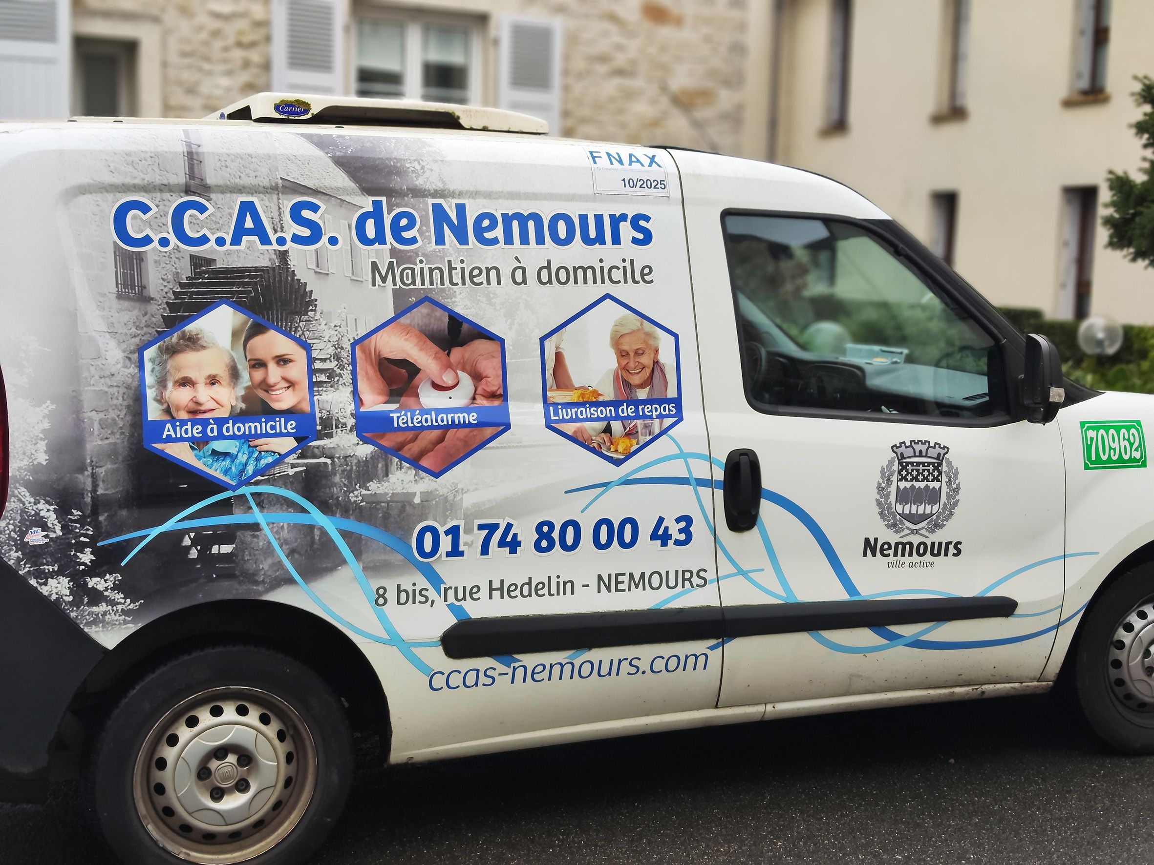 une camionnette blanche vue de côté, portant les coordonnées du CCAS de nemours