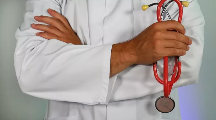 doctor holding red stethoscope