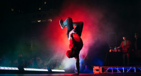 man doing breakdancing on gray surface