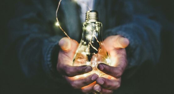 man holding incandescent bulb